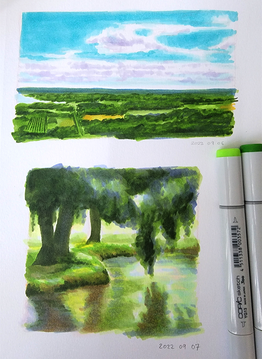 Two marker photo studies. The first is overlooking fields with a large blue sky with clouds. The second is the bank of a lake framed by trees.