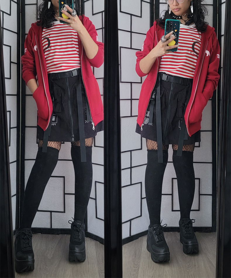 Red and black techwear outfit with belt detail skirt and red/white stripe shirt.