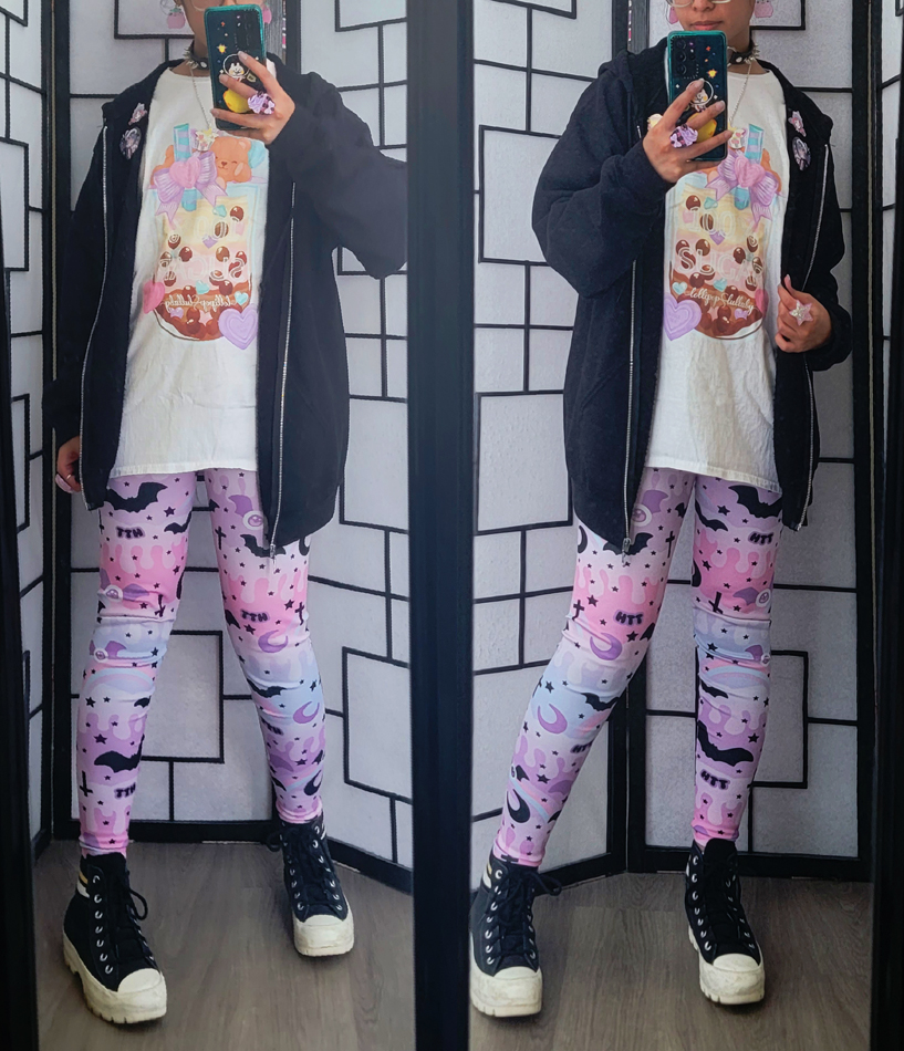 Pastel goth outfit with an oversized boba graphic shirt and colorful leggings with bats.