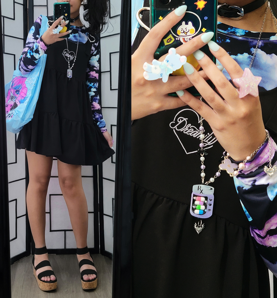 A black and pastel outfit with a black tiered sleveless dress layered over a night sky print top.
