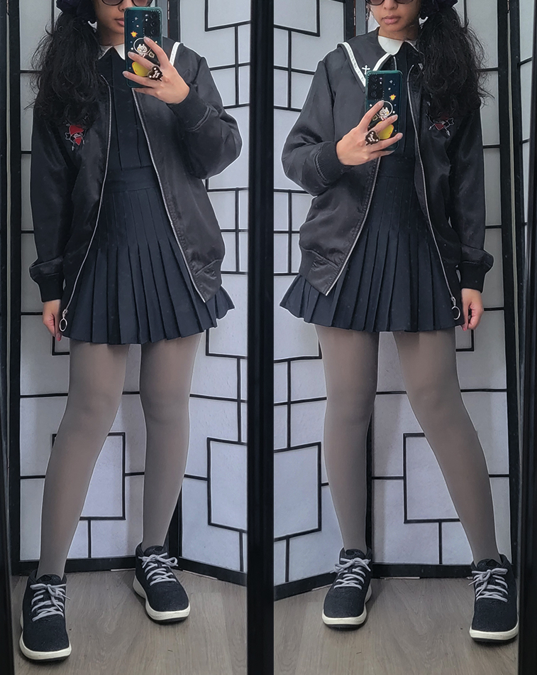 A casual outfit featuring a vampire-themed bomber jacket and a pleated dress with a peterpan collar.