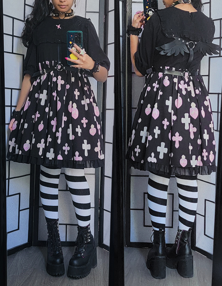 A halloween coordinate with a black and pastel print dress and black angel wing harness.
