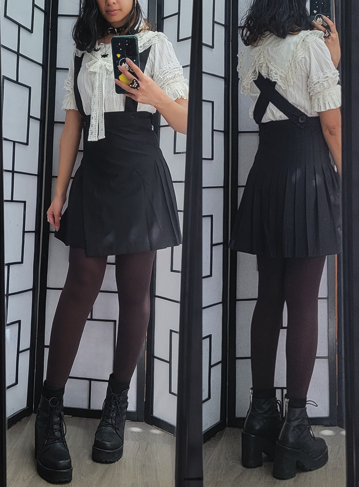 A black and white girly kei coordinate with a white sailor blouse and pleated suspender skirt