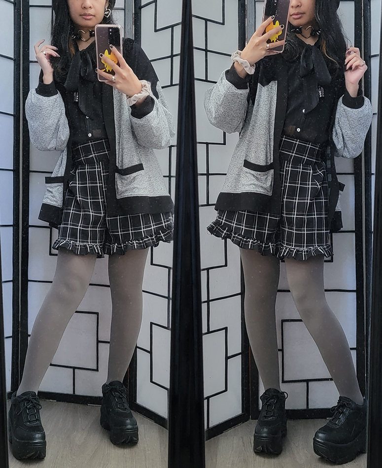 A black, white, and grey girly kei outfit featuring plaid shorts and a melting design cardigan