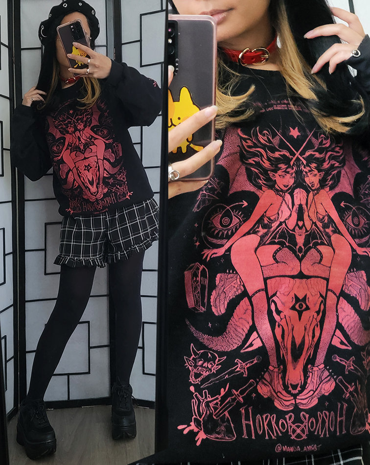 A red and black casual outfit featuring a crewneck sweater with a large gothic illustration.