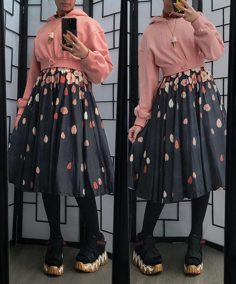 A pink, black, and gold casual outfit featuring a cropped pink hoodie and a sakura petal midi skirt