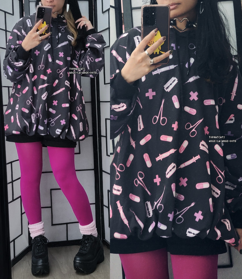 An oversized menhera print hoodie paired with black shorts, hot pink tights layered with pastel pink socks, and black platform sneakers.