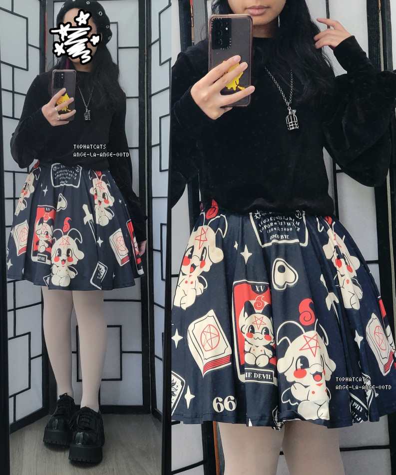 A black, red, and off white dark fashion outfit featuring an adorable cartoon baphomet print skirt.