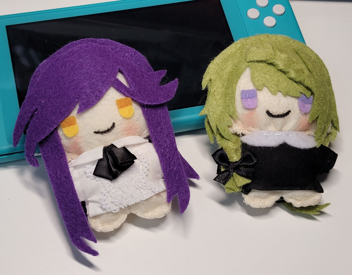 Custom Mizuki and Dahut plush characters with a Nintendo Switch Lite for scale